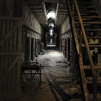 Dark hall with a staircase leading to the second floor at Eastern State Penitentiary. Philadelphia,PA