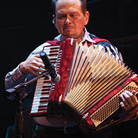 A man playing an acordian