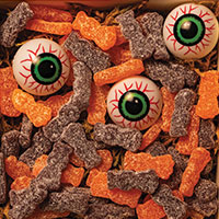 Eyeballs and Sour Patch Kids in a wooden conainer