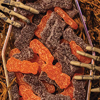Skeleton hands grabbing at a coffin full of Zombie Sour Patch Kids