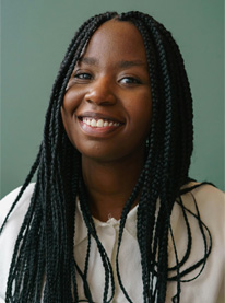 Image of trainer Nevaeh. Long black hair, dark complexion, beige shirt