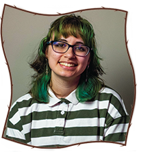 Image of me wearing green and brown shoulder length hair, blue glasses, and a green/white striped shirt